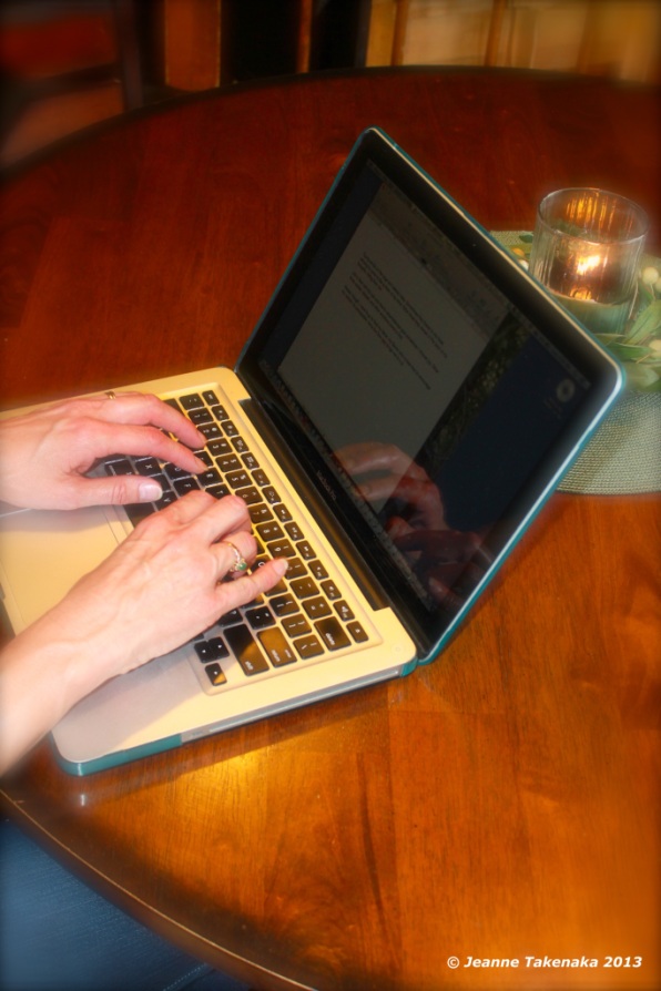 A woman typing on her laptop