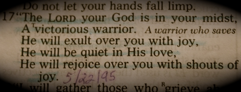 Image of the Bible verse: Zephaniah 3:17—"The Lord your God is in your midst; A victorious warrior. He will exult over you with joy, He will be quiet in His love, He will rejoice over you with shouts of joy."